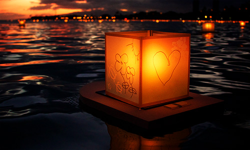 how to be present in the now - square paper lantern floating on water at night