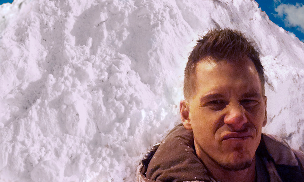 The Best Advice So Far - digging out - Erik with *yuck* face standing in front of a mountain of plowed snow