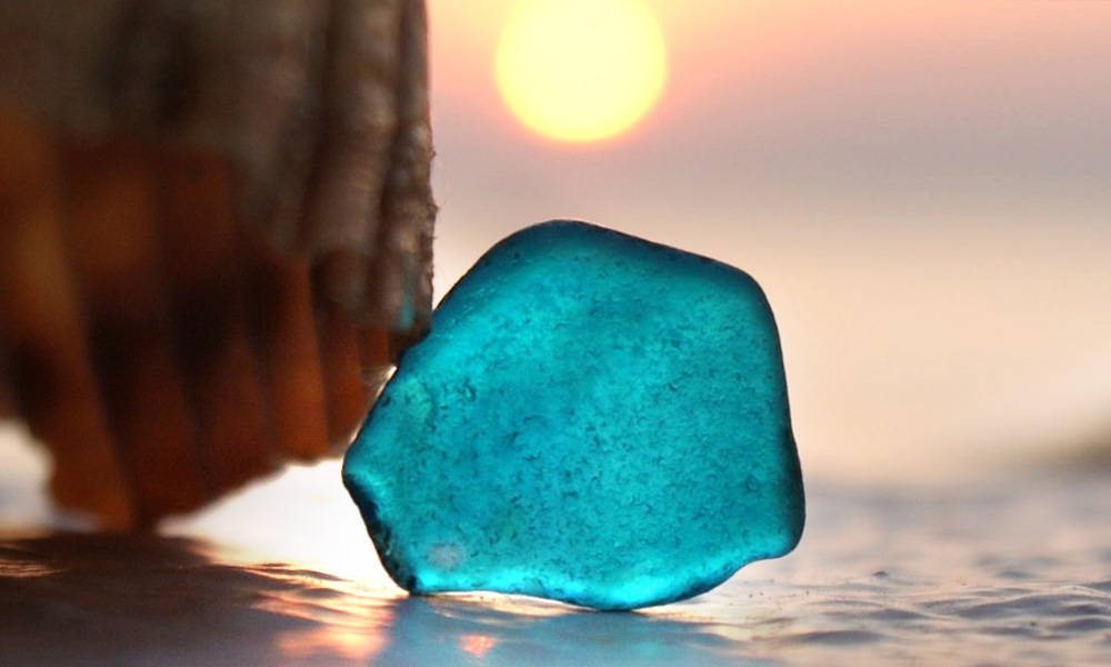 The Best Advice So Far: Sea Glass - light blue sea glass on sand against sunset
