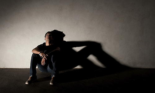 asking for help - needy - man sitting alone in the shadows